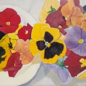 Colorful pansies arranged on white plates
