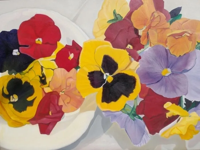 Colorful pansies arranged on white plates