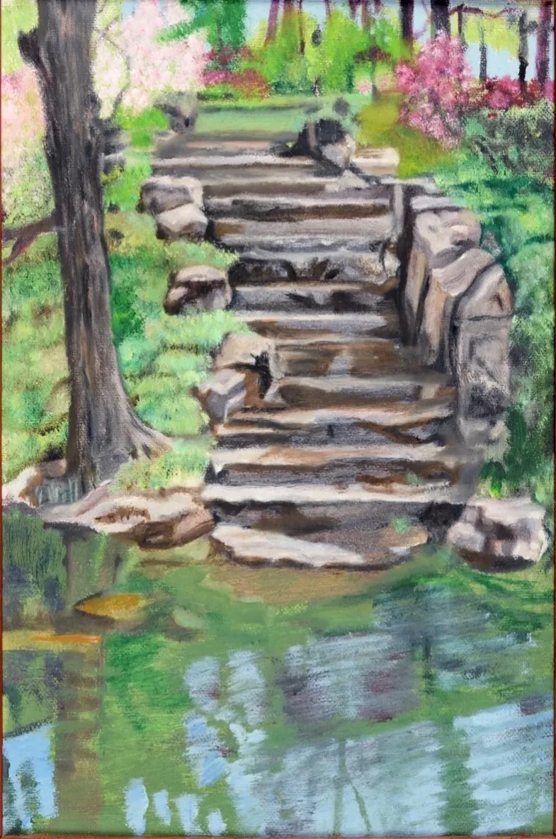 Stone steps rising from pond in garden